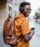 Shot of a young man using smartphone and listening to music outdoor in the city.