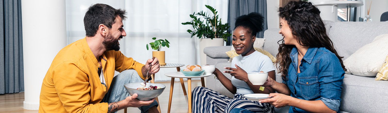 Group of young adults enjoying breakfast at home