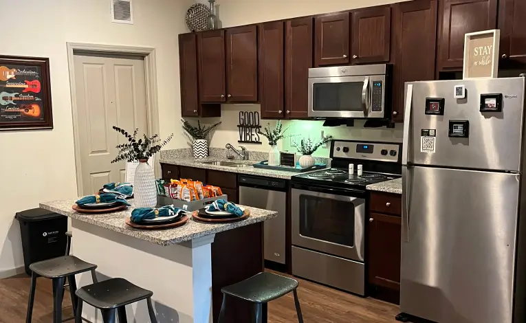 a student apartment kitchen with stainless steel appliances